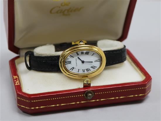 A ladys 18ct gold Cartier oval cased wrist watch, with Cartier box.